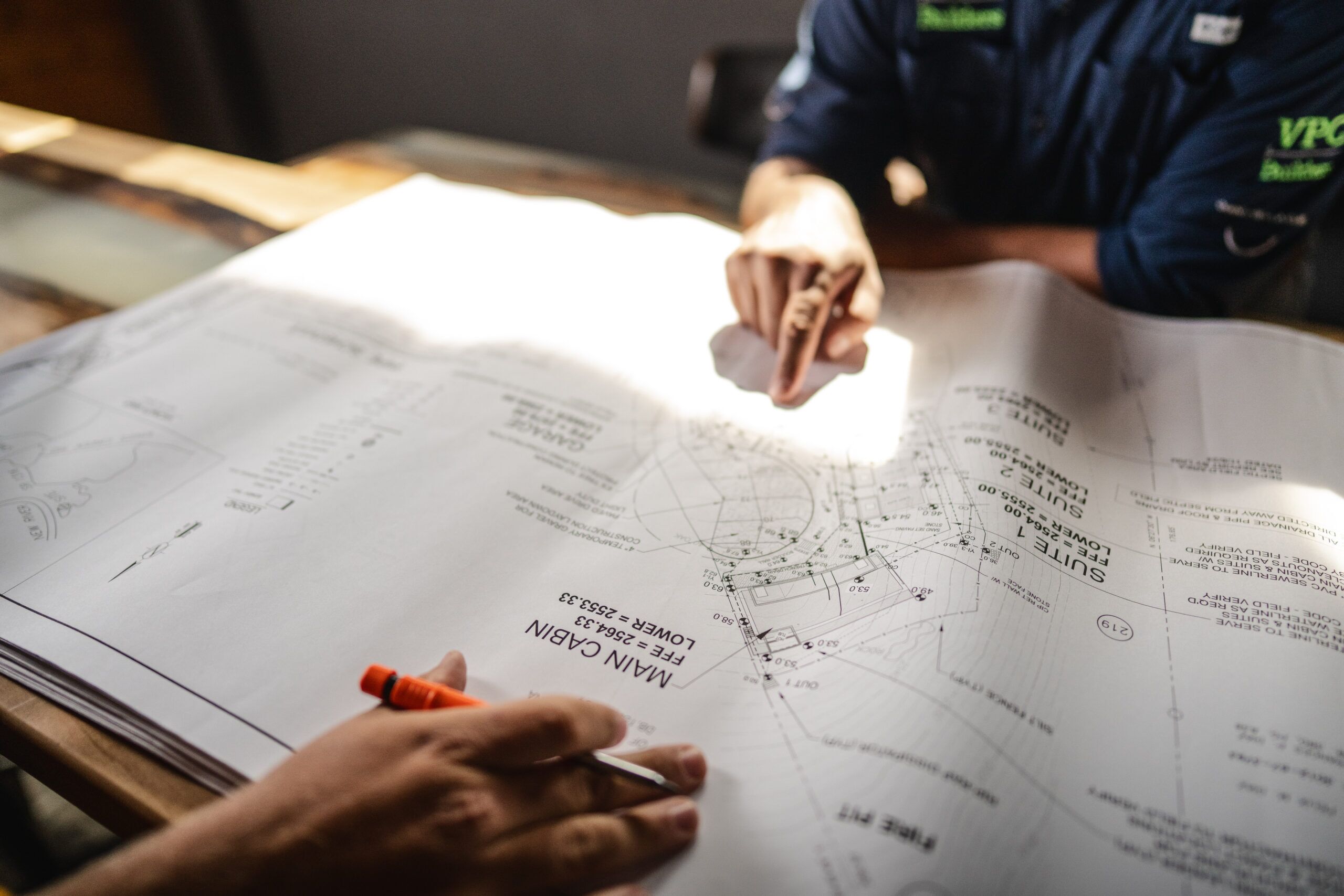 Image with 2 hands and a design document.