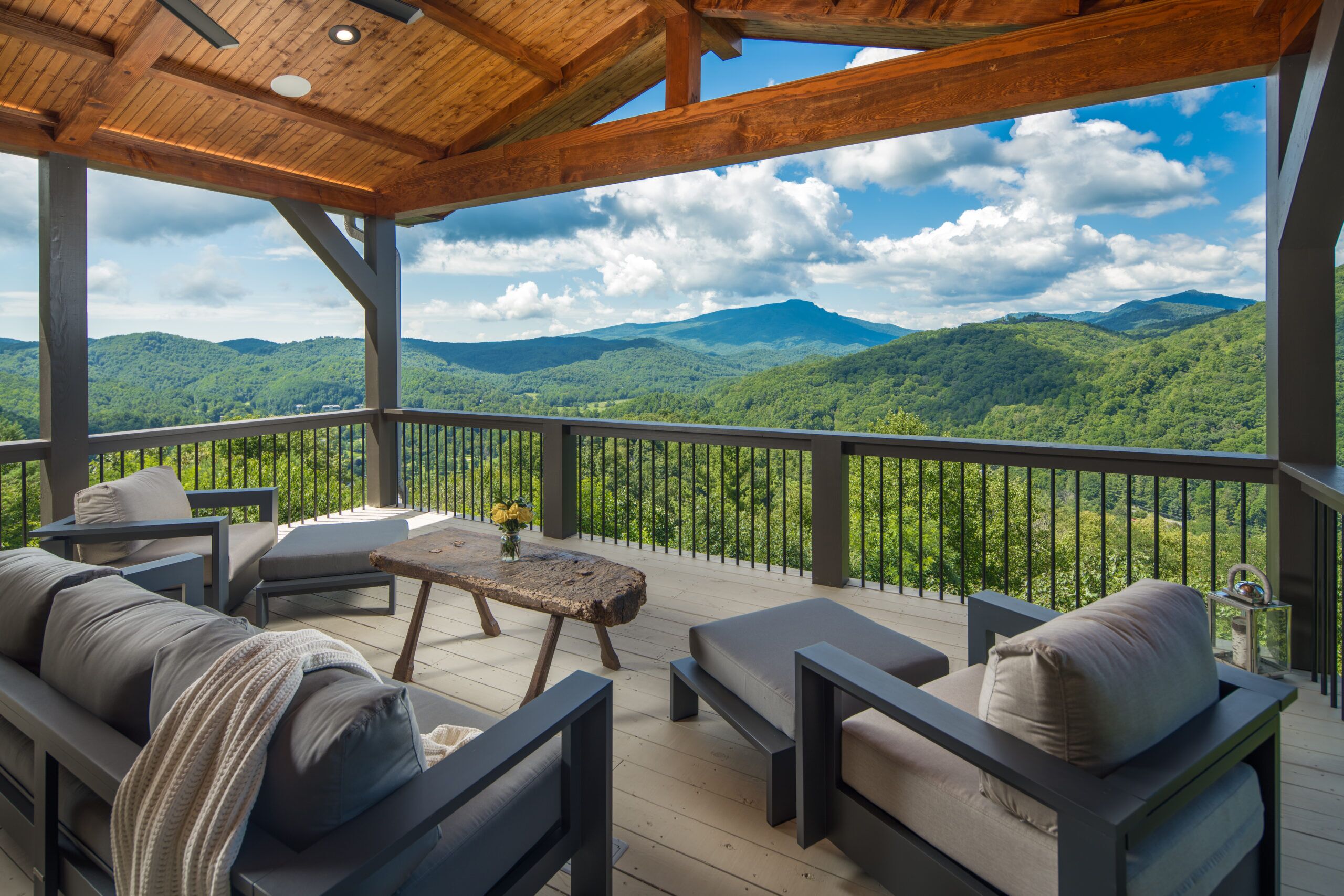 RBS-VPC-Hancock Deck Project-003 Covered deck with outdoor seating overlooking green mountains